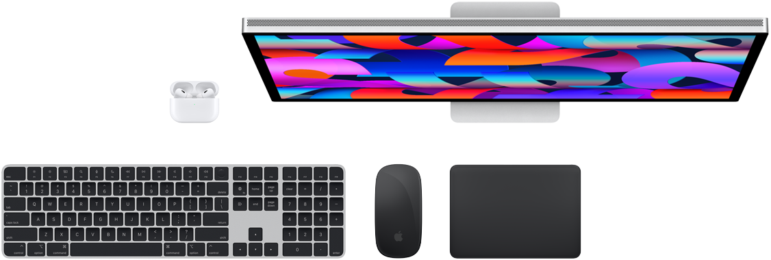 Top view of Mac accessories: Studio Display, AirPods, Magic Keyboard, Magic Mouse and Magic Trackpad