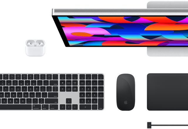 Top view of select Mac accessories: Studio Display, Magic Keyboard, Magic Mouse, Magic Trackpad, AirPods and MagSafe charging cable