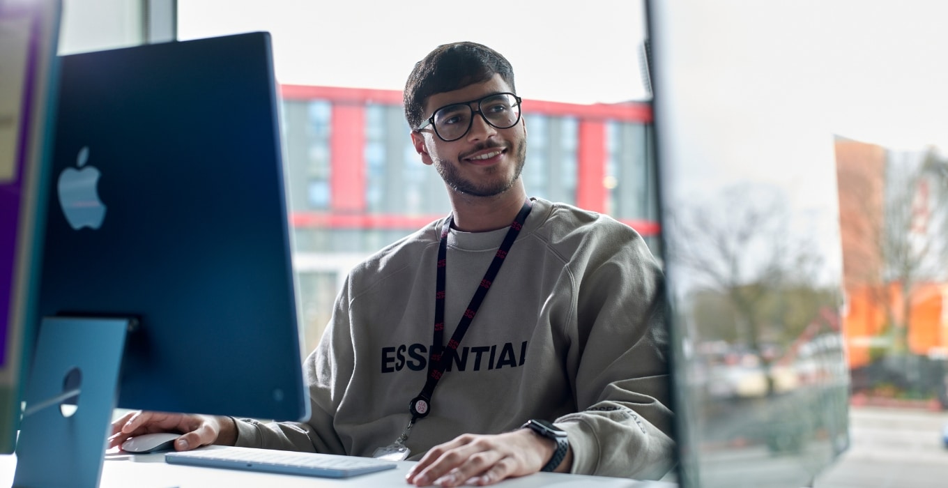 Student on blue iMac