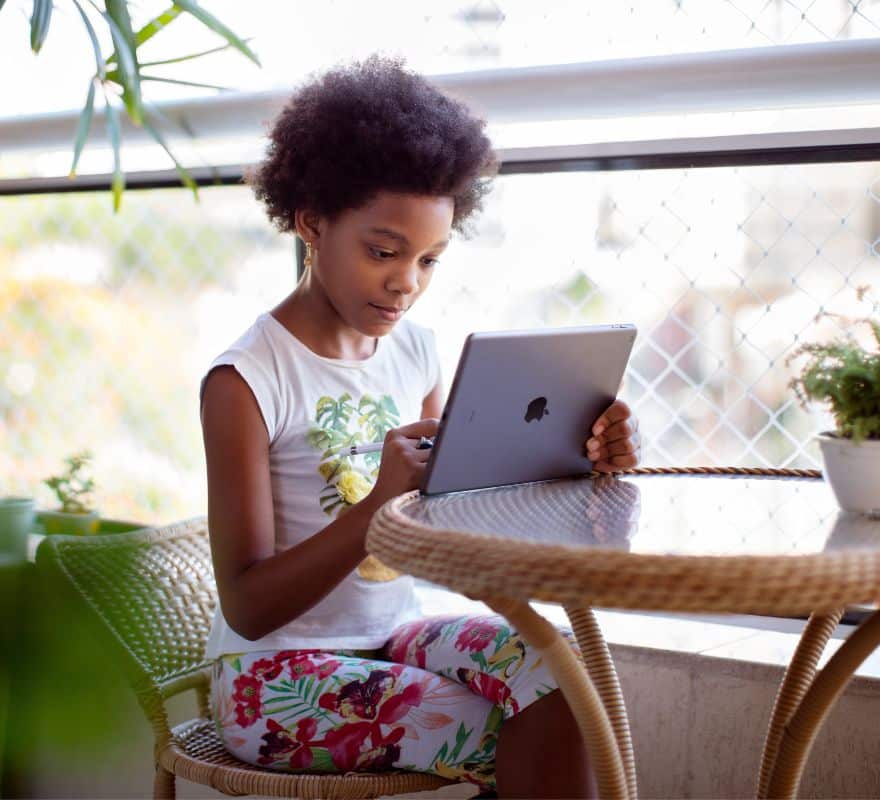 A child using their iPad at home.